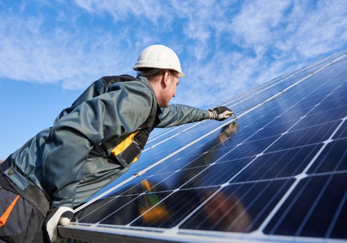 A worker inspecting solar panels, making sure they collect Solar Power in Richmond VA