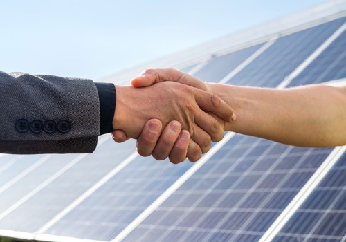 People shake hands after installing Solar Panels in Peoria Heights IL