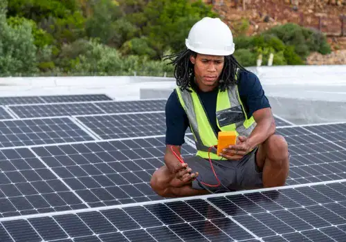 african man installing solar panels on a roof of a house picture id1285123887.jpg